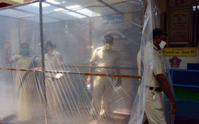 In picture: The police use a tunnel in order to sanitise themselves amid lockdown in Dahisar.